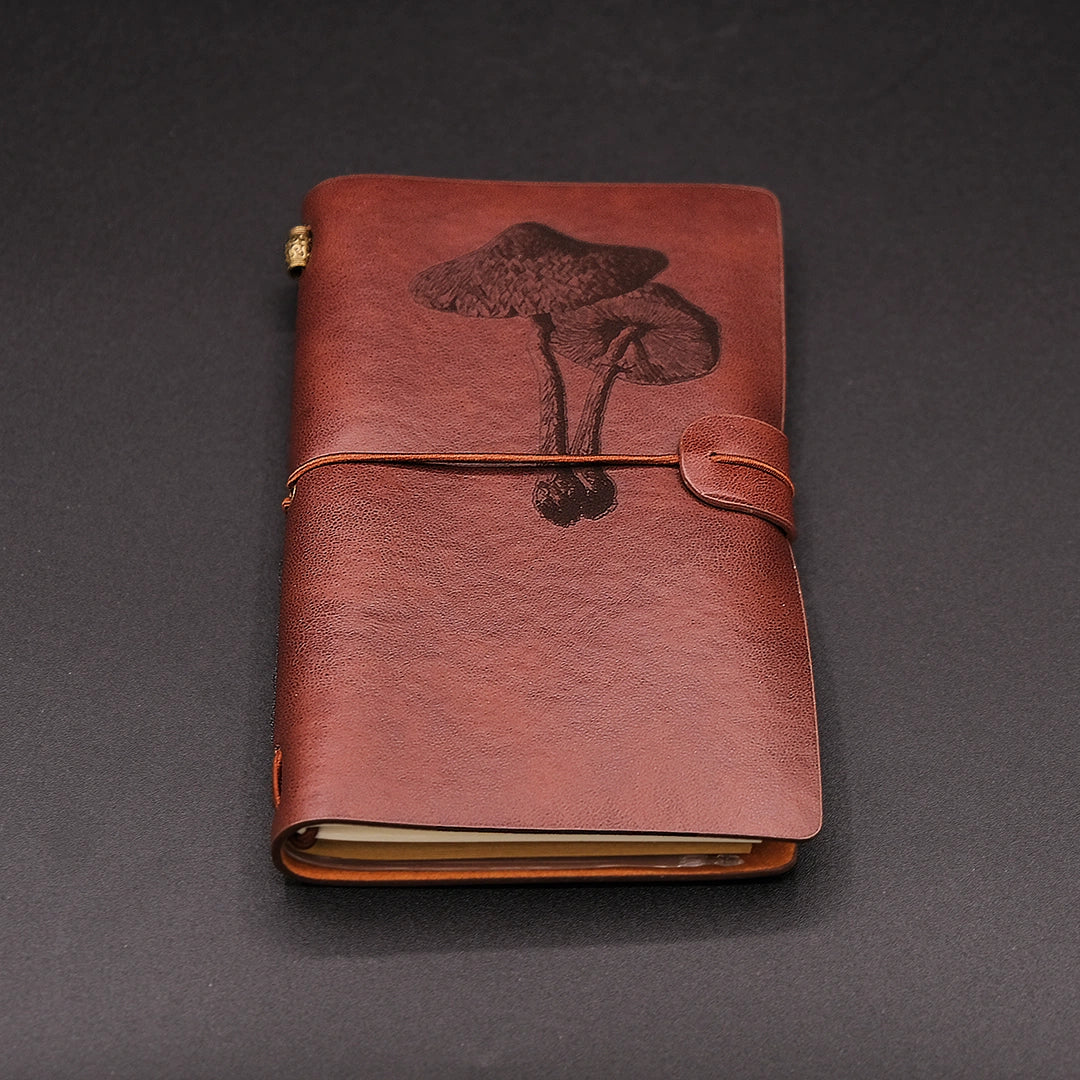 A vegan leather diary with a mushroom engraving, perspective view