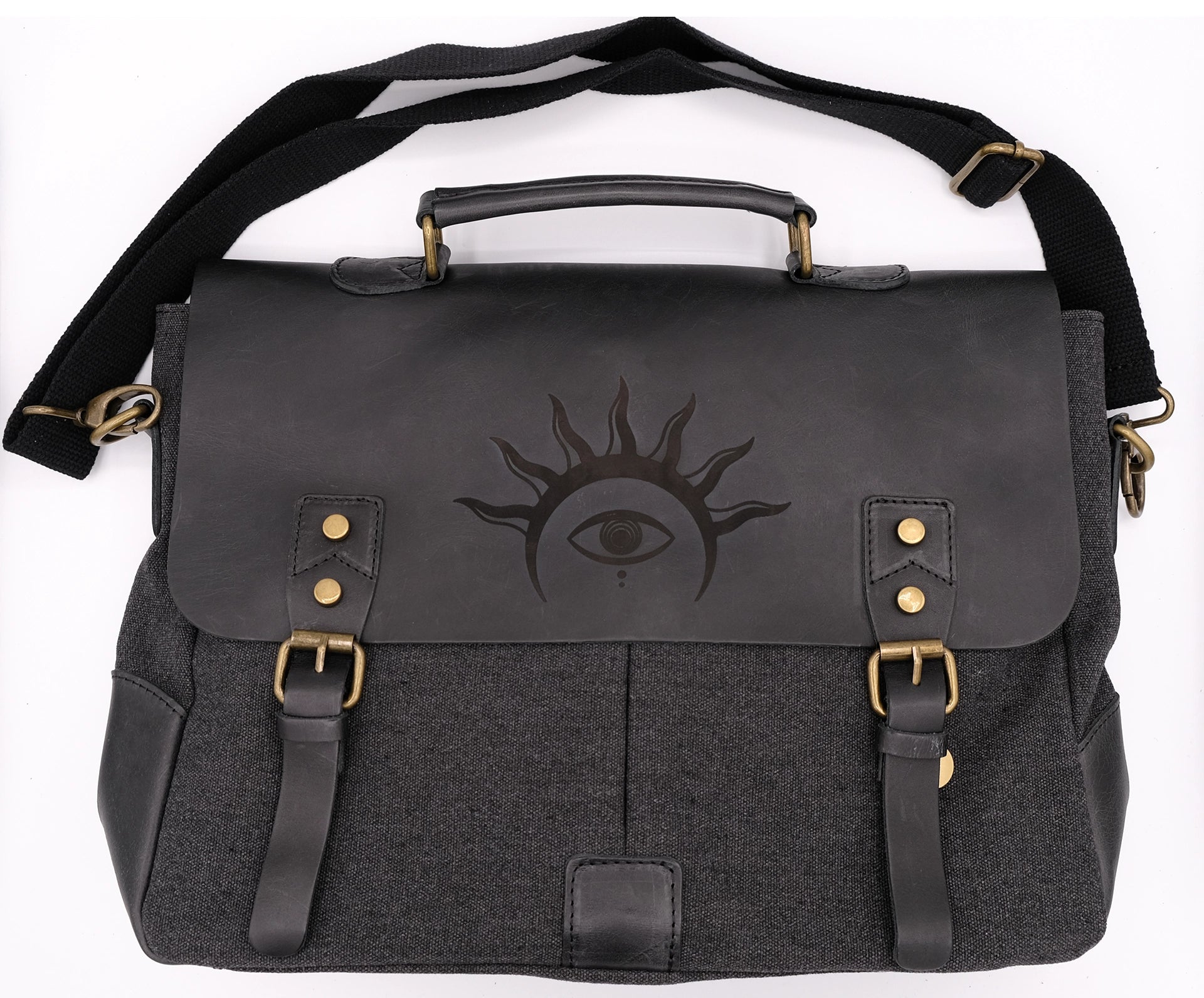 A black leather satchel engraved with a mystic eye with a solar crown. Dark academia style