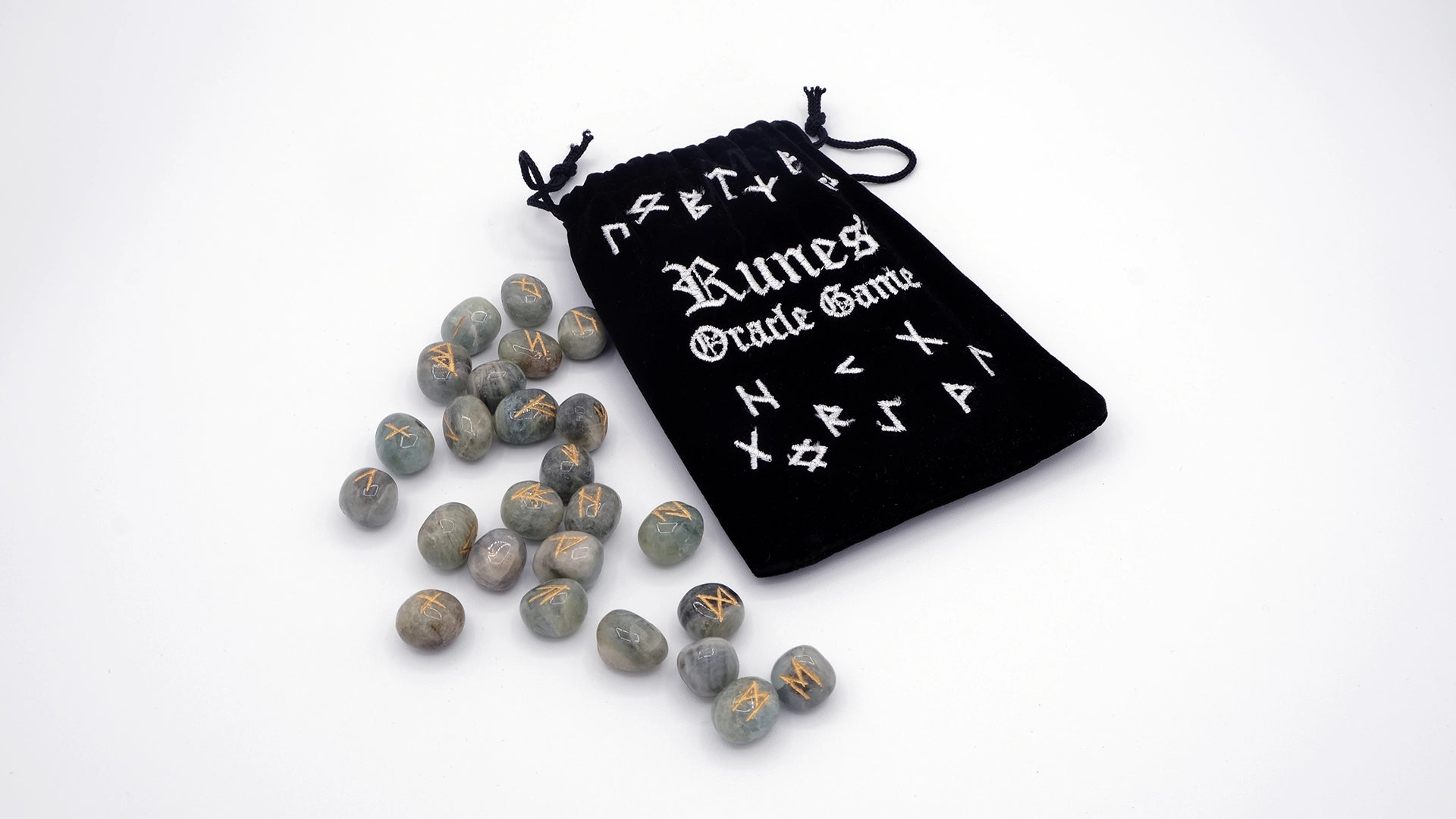 A set of nordic runes carved over aquamarine stones