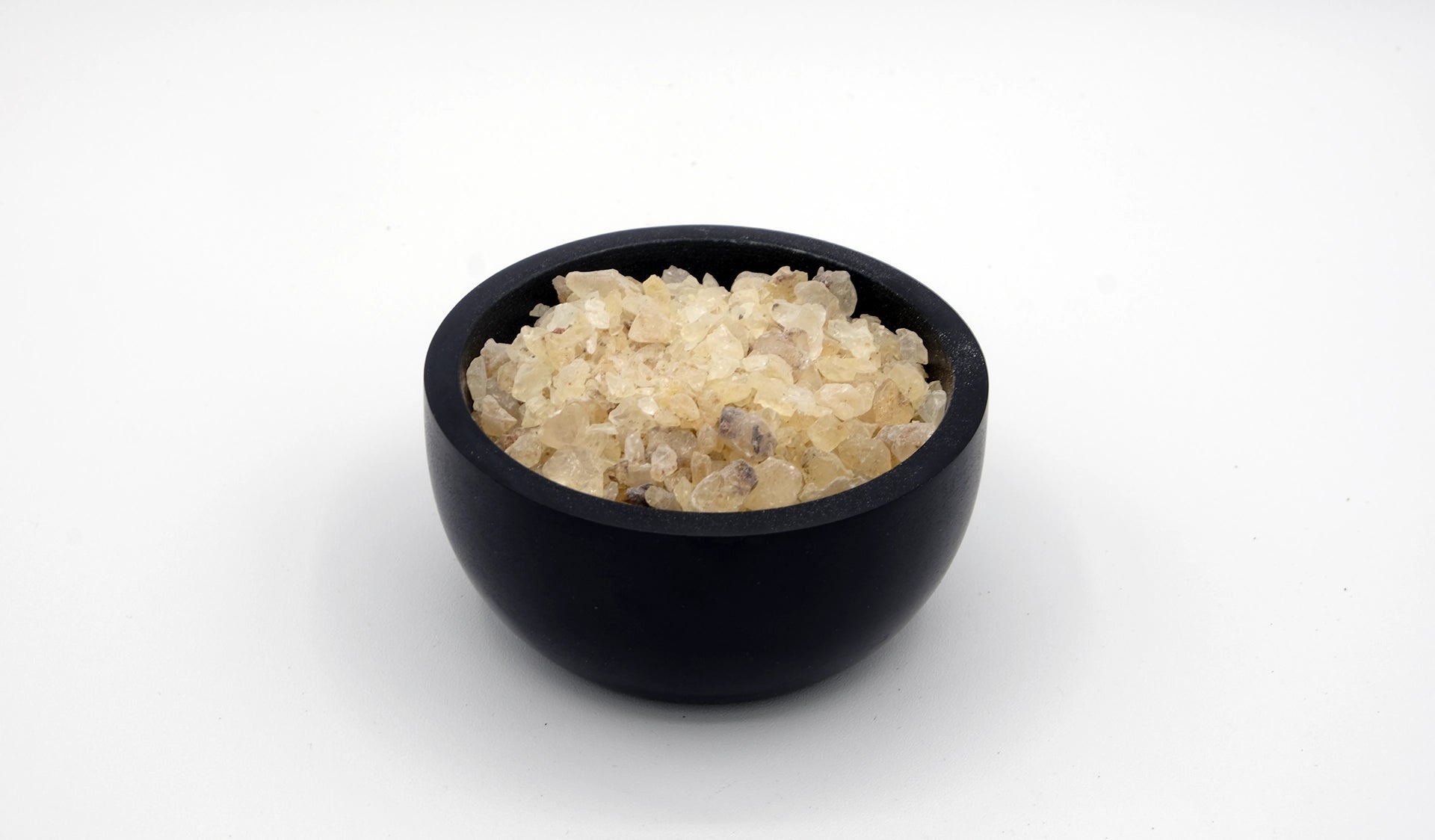 Black stone cup full of copal incense resin