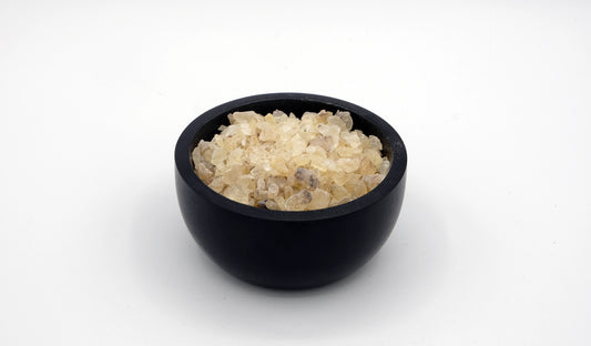 Black stone cup full of copal incense resin