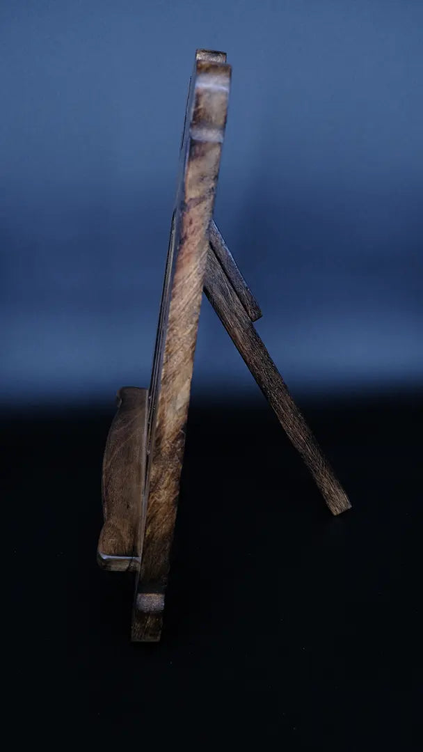 A wooden fantasy bookstand over a black background, lateral view