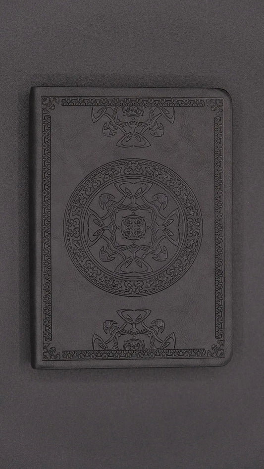 A black diary with elegant oriental decorations, front view