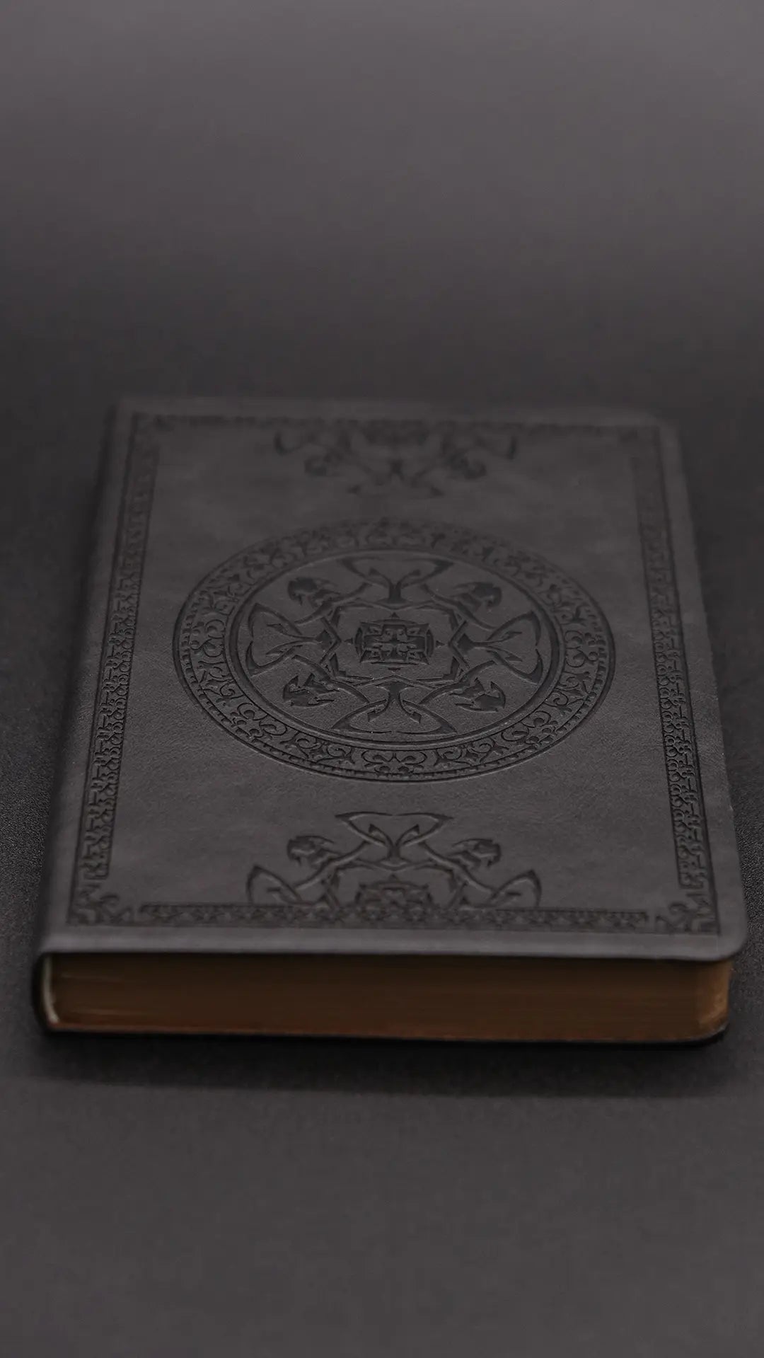 A black diary with elegant oriental decorations, perspective view