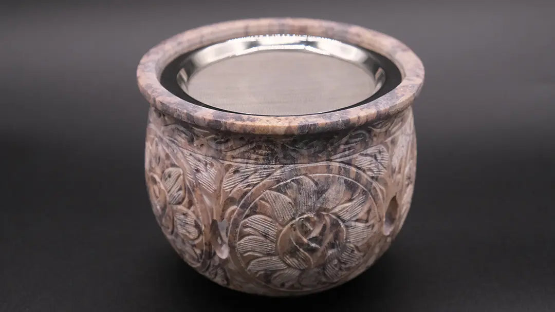 Steatite Incense Burner with beautiful ornaments on the black background.