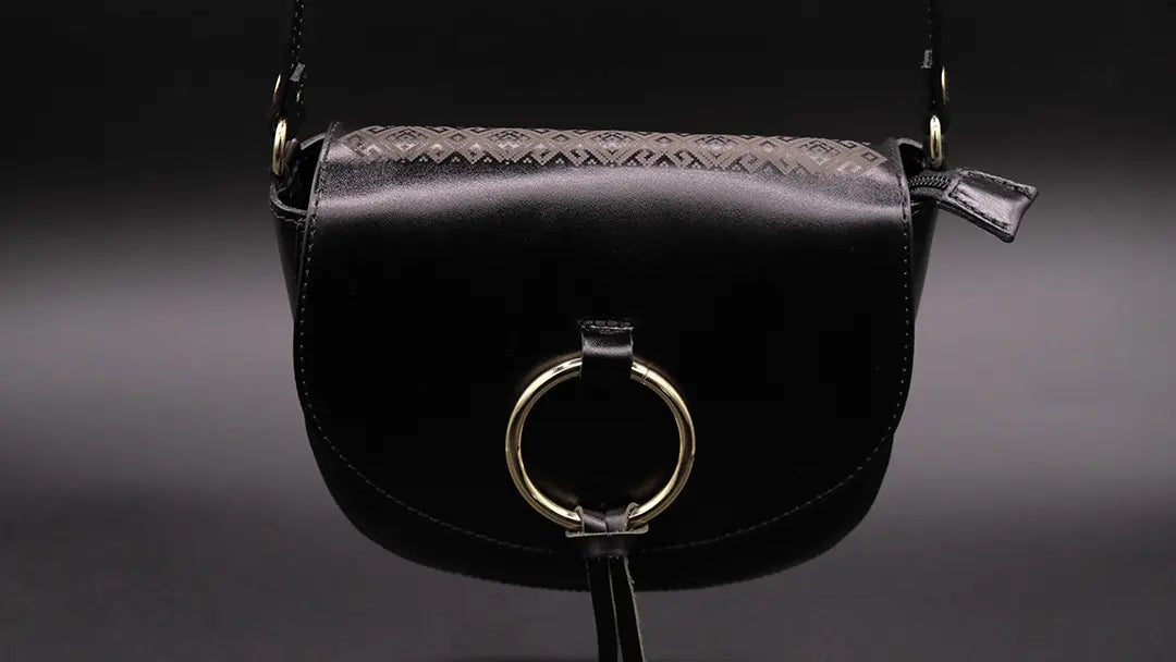 Leather Black Bag over the black background.