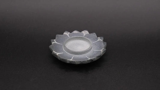 Steatite Lotus Candle Holder on the black background.