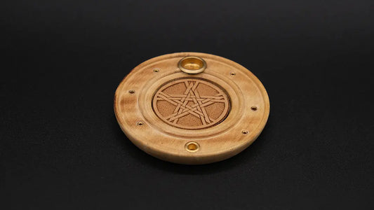 Round Pentacle Incense Burner made of wood on the black background.