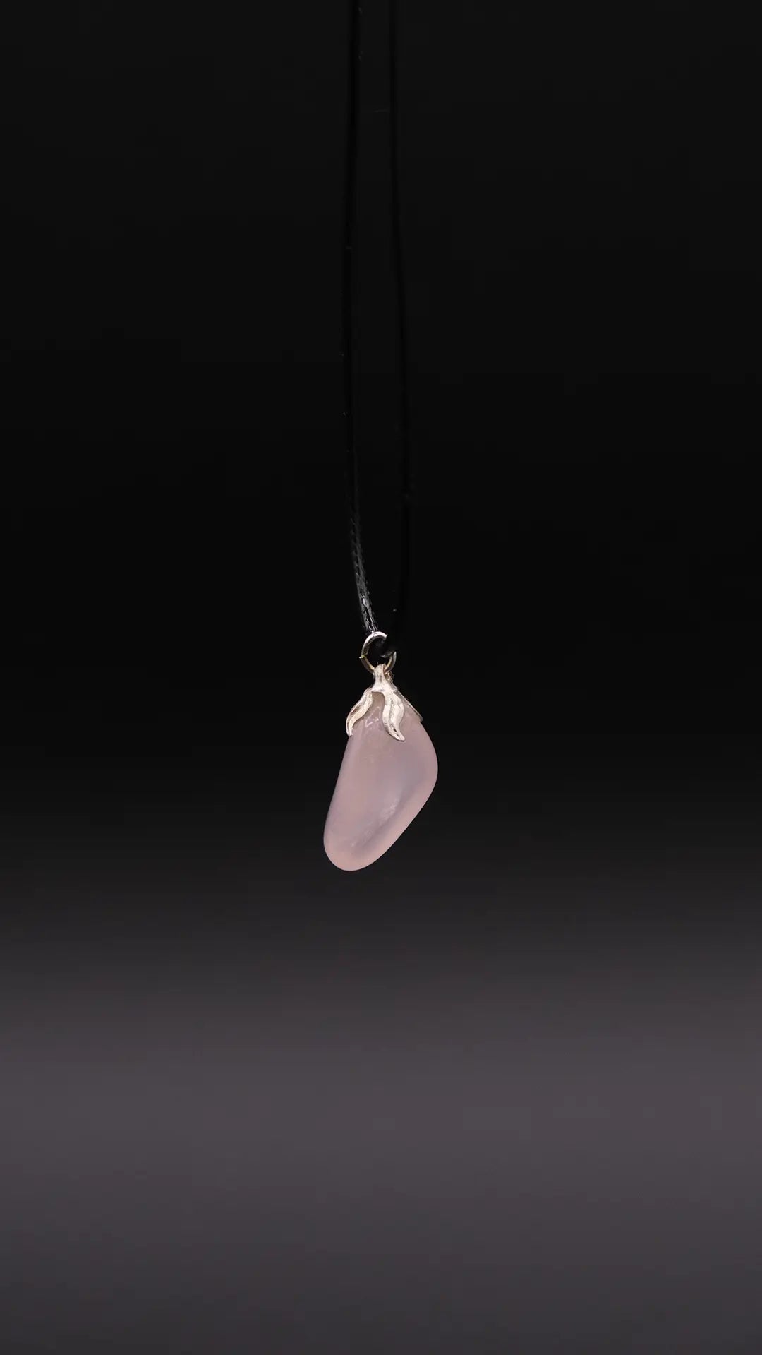 Rose Quartz Pendant over black background.