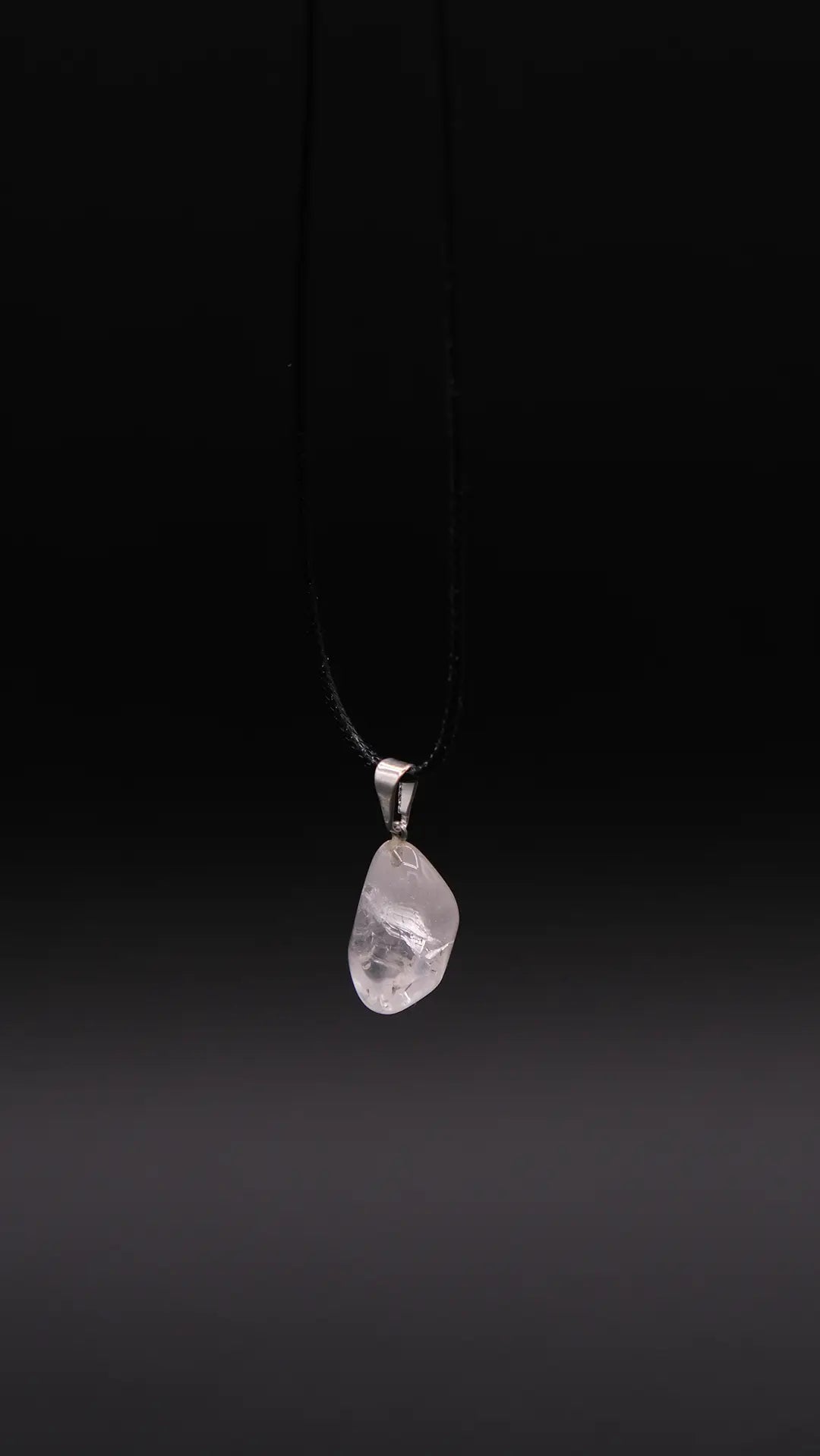 White Quartz Pendant over the black background.