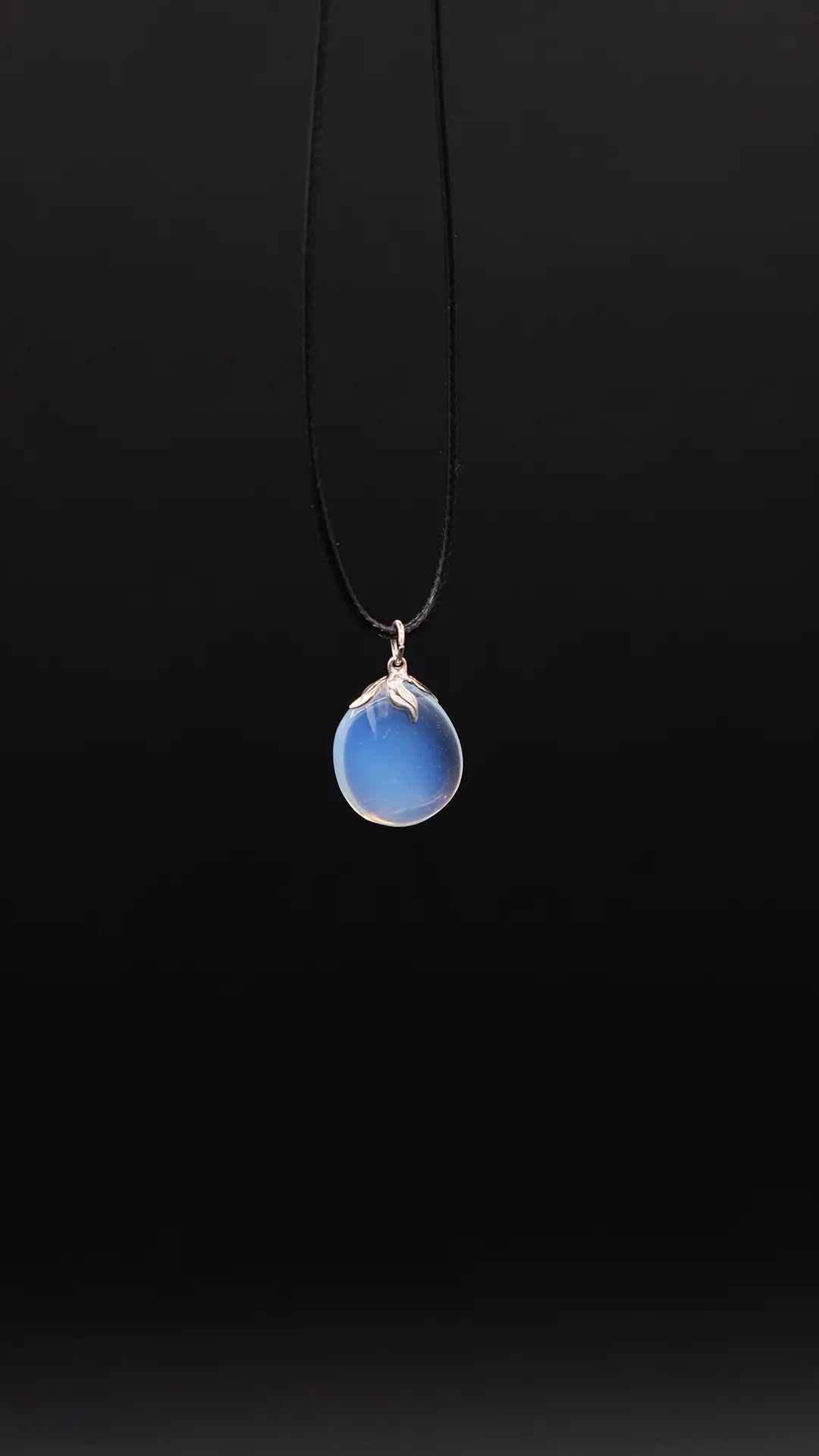 Opalite Pendant over black background.