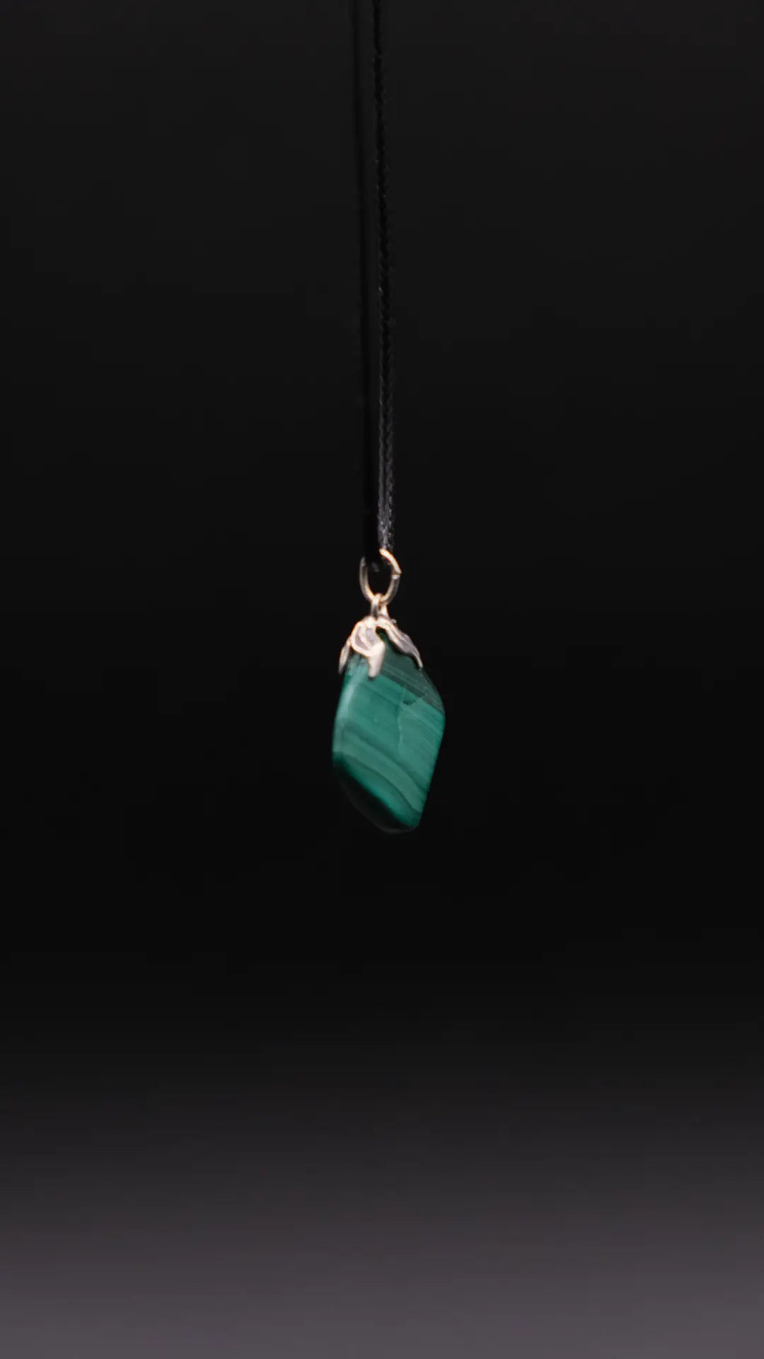 Malachite Pendant over the black background.