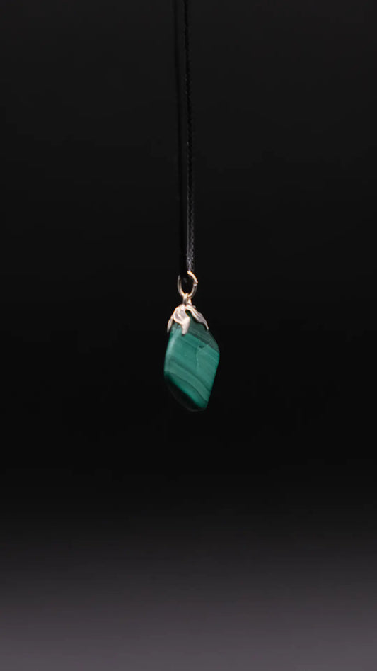 Malachite Pendant over the black background.