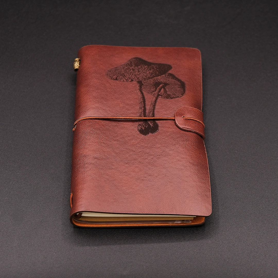 A vegan leather diary with a mushroom engraving, perspective view