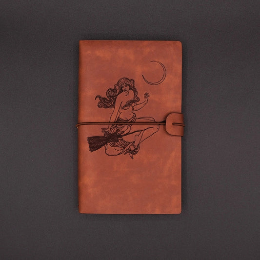 A vintage vegan leather diary engraved with a witch under the moon