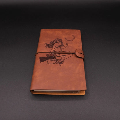 A vintage vegan leather diary engraved with a witch under the moon