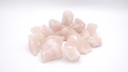 A composition of rose quartz stones in white background