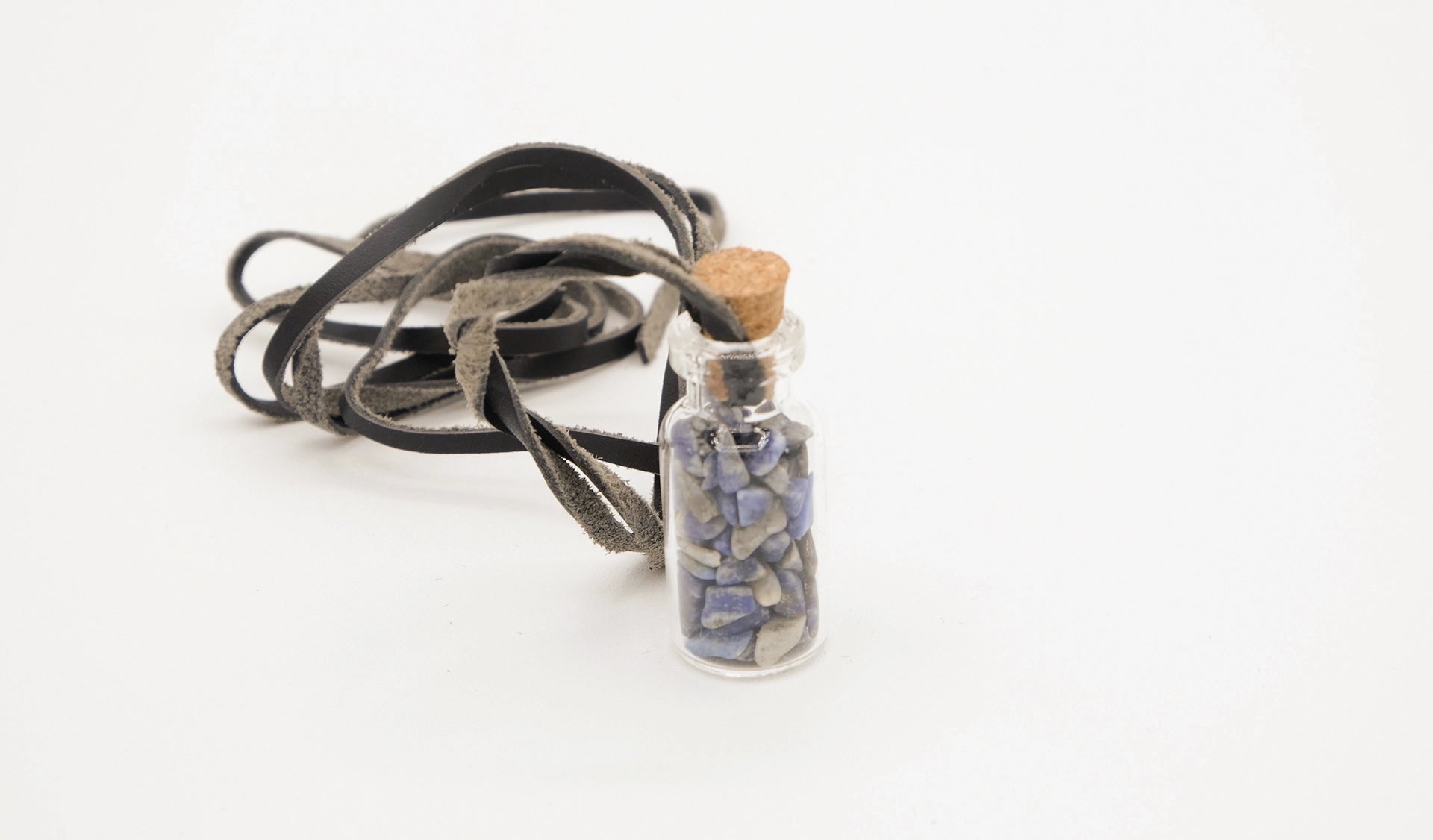 pendant made with a little glass bottle filled with lapis lazuli shards