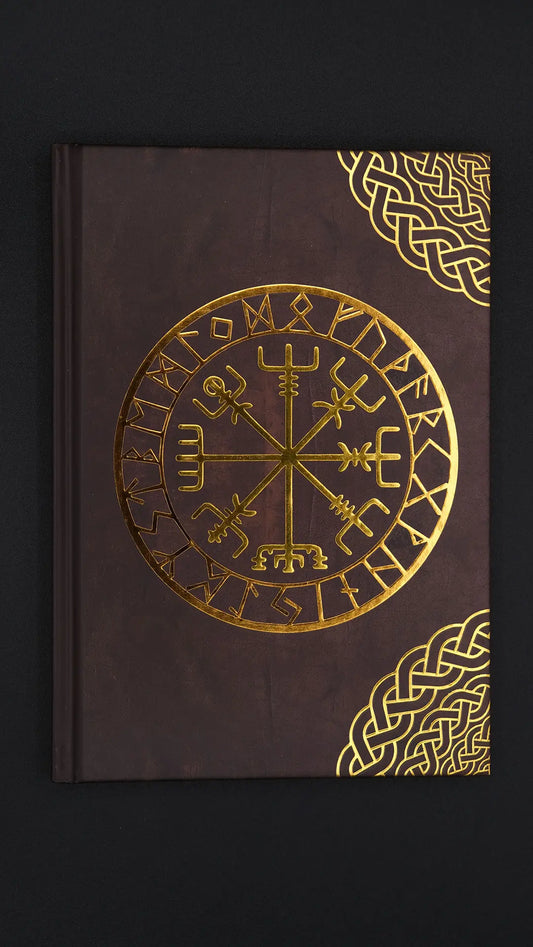 Journal with rune ornamented on the front over the black background.