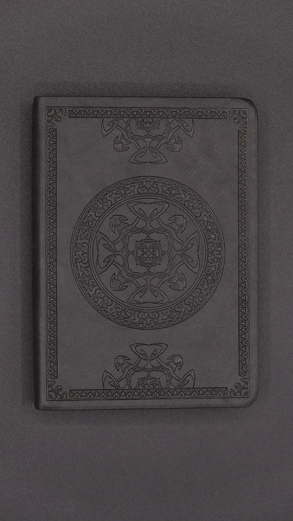A black diary with elegant oriental decorations, front view