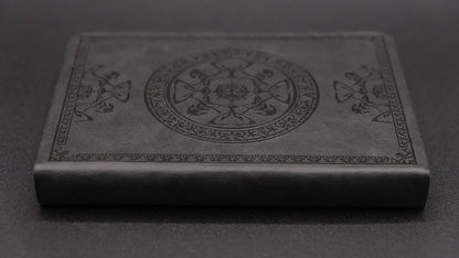 A black diary with elegant oriental decorations, lateral view