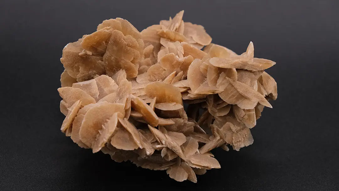 A big desert rose stone placed over a black background