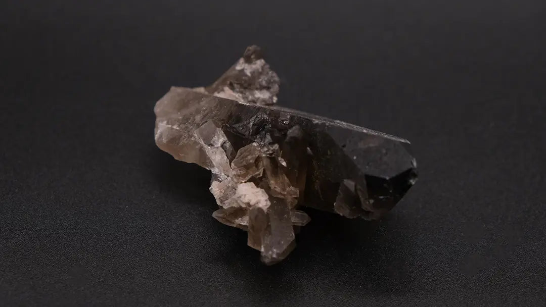 Smoky Quartz Druse on the black background.