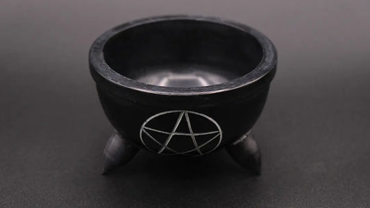 Cup in black steatite with a pentacle decoration, over a black background