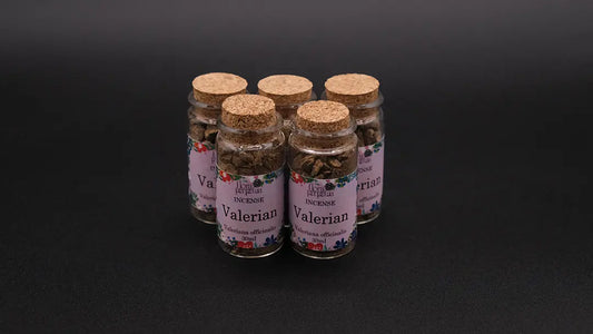 Five bottles of Valerian Incense Herb on the black background.