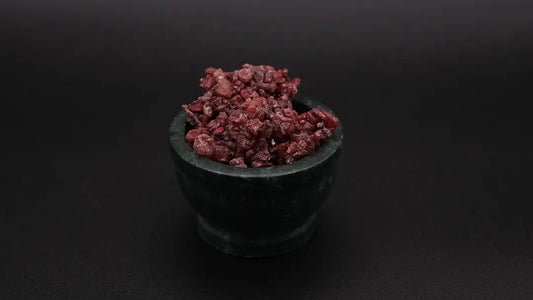 A dark green mortar full of red dragon's blood incense