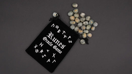 Runes Oracle Games engraved on the aquamarine stone over the black background.