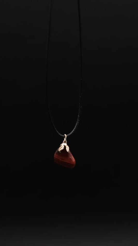 Red Tiger's Eye Pendant on the black background.