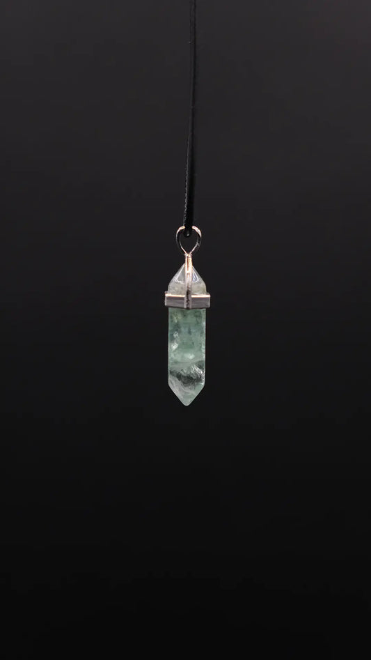 Prism Pendant made from Fluorite on the black background.