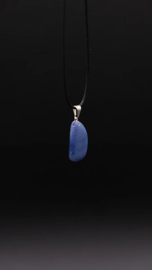 pendant in blue quartz over a black background